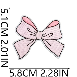 Detail showing pink cherry bow embroidery patch dimensions 5.1cm by 5.8cm on white background