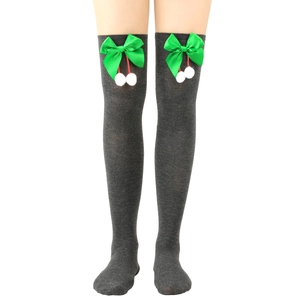 Detail of dark grey over-knee socks with green bow and white plush pom-poms