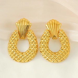 Detail view of 18K gold-plated drop earrings with geometric textured pattern design