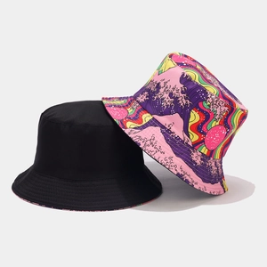 Flat lay of reversible bucket hats in plain black and vibrant psychedelic graffiti patterns