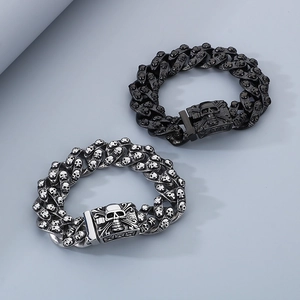 Macro detail of heavy punk skull link bracelets in silver and black stainless steel