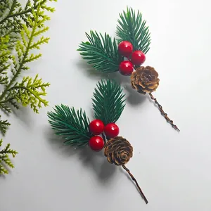 Detail of artificial pine needle stem with red berries and natural pinecone for DIY crafts