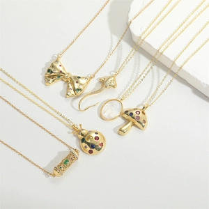 Gold plated mushroom and butterfly pendant necklaces displayed on a minimalist background