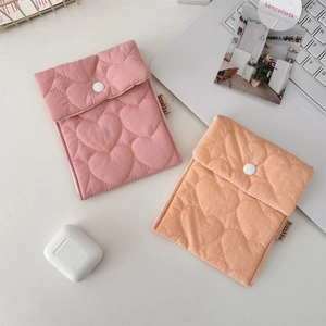 Close-up of quilted heart pattern and snap closure on candy colored sanitary pouches