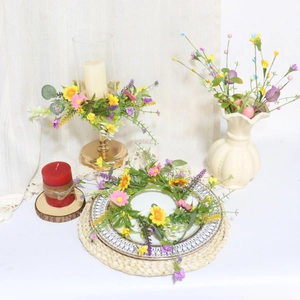 Detail of faux spring daisies and lavender wreath with a rustic linen bow decoration