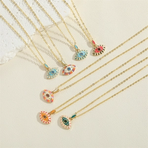 Golden Evil Eye necklaces with colorful enamel pendants and zircon stones on beige base