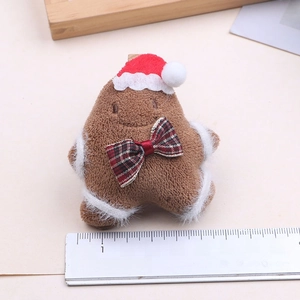 Plush Christmas gingerbread man ornament with Santa hat and plaid bow accessory