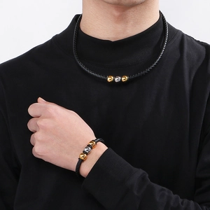 Mens woven black leather bracelet and necklace set with gold and silver metal beads