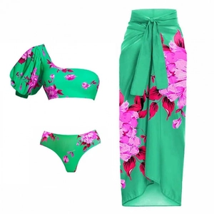 Three-piece floral print bikini set with one-shoulder top and long sarong skirt in emerald