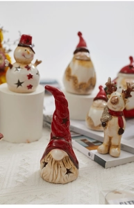 Close-up of a festive gnome ceramic figurine with star cutouts and holiday ornaments