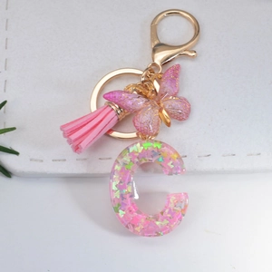 Pink glitter resin letter C keychain with butterfly pendant and suede tassel charm