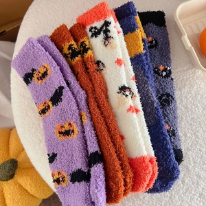 Cozy Halloween coral fleece socks with pumpkin and clown patterns on soft plush mat