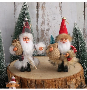 Detailed view of Santa Claus figurines with gray plaid and red fur on wooden bases