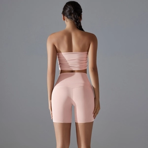 Rear view of pink two-piece yoga set with tube top and high waist cycling shorts