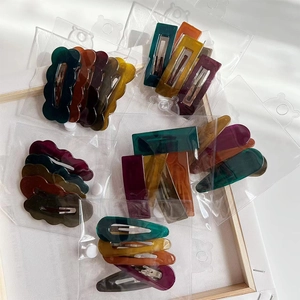 Macro shot of assorted colorful marble texture acetate hair clips in packaging