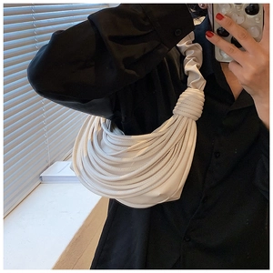 Detail of creative pleated white shoulder bag with multi-strand rope design for women