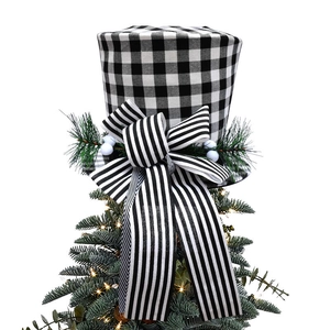 Detail of buffalo plaid Christmas tree topper hat with striped bow and pine needles