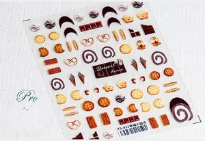 Dettaglio degli adesivi per unghie 5D TS-422 con motivi di dolci come biscotti e gelati