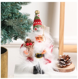 Detailed close-up of knitted Christmas gnome ornaments featuring red and white holiday textures