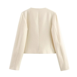 Detail view of the cropped cream white blazer's textured fabric and precise back stitching