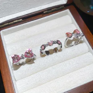 Three-piece ring set featuring pink heart crystals and sparkling bowknot designs in a box