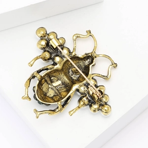 Macro detail of the back pin clasp and vintage gold finish on the bee brooch