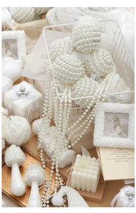 Detail of white pearl Christmas ornaments with miniature gift boxes and beads decor