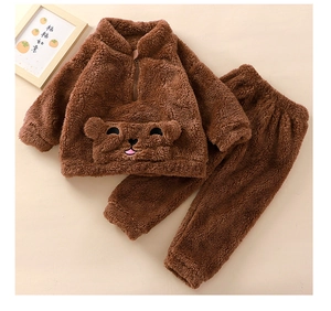 Detail of warm brown flannel pajama set with a cute bear embroidery on the front pocket