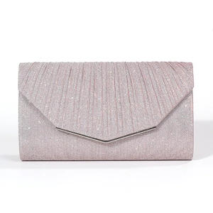 Detail of pink glitter fabric evening bag with vertical pleats and V-shaped metal trim