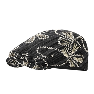 Retro denim flat cap with white floral embroidery and gold sequins on a black finish