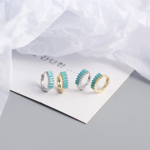 Detailed macro of S925 silver huggie earrings with inlaid rectangular turquoise stones