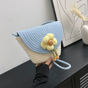 Summer woven flower bucket bag with blue flap and cream crossbody strap for women