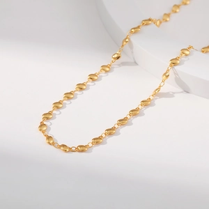 Detailed view of oval bean chain necklace in 18K gold plated brass with shiny metallic finish