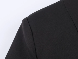 Detail of shoulder seam and twill fabric texture on a black business blazer jacket