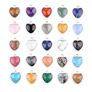 Collection of 25 natural heart-shaped gemstone pendants with metal bails on white background