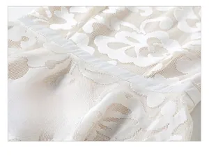 Close-up of ivory lace embroidery dress featuring detailed floral patterns and waist ribbon