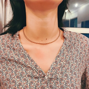 Elegant gold titanium steel beaded necklace for women worn on the neck in minimalist style