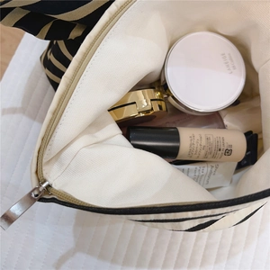 Macro shot of striped cotton makeup bag interior showing large storage capacity