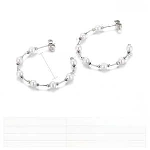 Macro shot of 34mm C-shape stainless steel earrings featuring seven white shell pearls