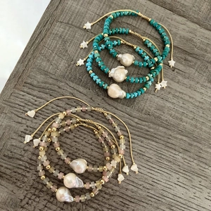 Close-up of Bohemian beaded bracelets featuring Baroque pearls and adjustable woven cords
