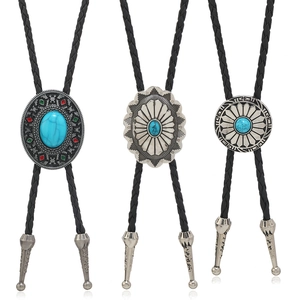 Three vintage turquoise bolo ties with braided black cords and silver-tone floral pendants