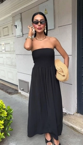Close-up of elegant black tube top maxi dress with elastic waist and flowing skirt detail