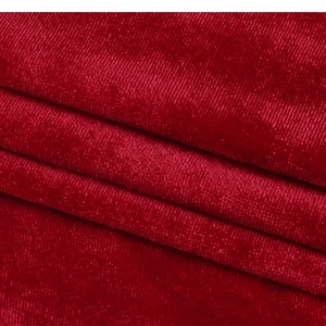 Macro shot of deep red corduroy fabric texture and vertical striped pattern detail