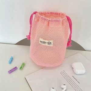 Detailed view of pink mesh drawstring bag with a breathable texture and vibrant toggle