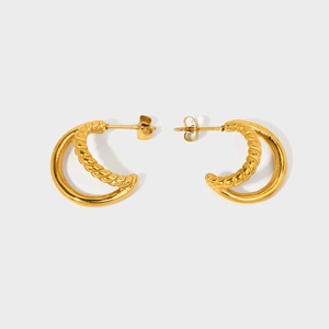 Close-up of dual-layer gold hoop earrings with twisted and polished stainless steel rings