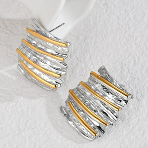 Artistic mixed metal earrings with irregular silver hammered texture and gold accents