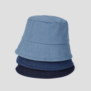 Detailed view of stacked blue bucket hats in cotton corduroy fabric with textured stripes