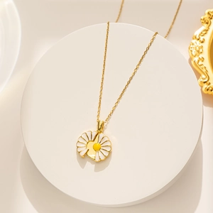 Golden stainless steel necklace with opening white daisy pendant on elegant stand