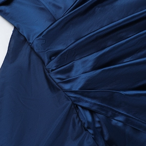 Detail of elegant dark blue satin dress showing silk texture and pleated design