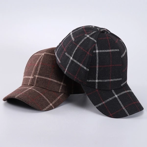Macro detail of houndstooth plaid wool fabric and texture on warm baseball caps